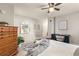 Bright bedroom with a ceiling fan, wooden dresser and large mirror at 970 S Dawson Way # 15, Aurora, CO 80012