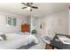 Bright bedroom features a ceiling fan, a work desk, and large dresser at 970 S Dawson Way # 15, Aurora, CO 80012
