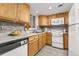 Charming kitchen with wood cabinets, modern appliances, and light-filled window at 970 S Dawson Way # 15, Aurora, CO 80012