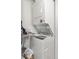 Compact laundry area equipped with a stacked washer and dryer unit for convenient laundry care at 970 S Dawson Way # 15, Aurora, CO 80012