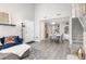Open-concept living room showcasing a modern design with light-colored floors, staircase, and ample natural light at 970 S Dawson Way # 15, Aurora, CO 80012