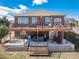 Expansive backyard featuring a two-story deck with a hot tub and lounge area at 5238 Clearbrooke Ct, Castle Rock, CO 80104