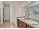 Bathroom featuring double sinks, a large mirror, and a tub/shower combo with glass doors at 5238 Clearbrooke Ct, Castle Rock, CO 80104