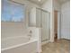 Bright bathroom featuring a soaking tub and glass-enclosed shower at 5238 Clearbrooke Ct, Castle Rock, CO 80104