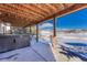 Stylish covered patio featuring a luxurious hot tub and serene mountain views at 5238 Clearbrooke Ct, Castle Rock, CO 80104