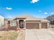 Charming single Gathering home with a three car garage, stone accents and neutral colored siding at 5238 Clearbrooke Ct, Castle Rock, CO 80104