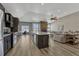 Modern kitchen with dark cabinetry, stainless appliances, and a large center island with seating at 5238 Clearbrooke Ct, Castle Rock, CO 80104