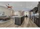 Modern kitchen with stainless appliances, granite countertops, breakfast bar seating and adjacent living room at 5238 Clearbrooke Ct, Castle Rock, CO 80104