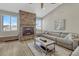 Inviting living room featuring vaulted ceilings, wood floors, a ceiling fan and a stone fireplace at 5238 Clearbrooke Ct, Castle Rock, CO 80104