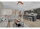 Open living space adjacent to modern kitchen with stainless appliances, large island and breakfast bar seating at 5238 Clearbrooke Ct, Castle Rock, CO 80104