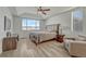 Spacious main bedroom featuring a ceiling fan, seating area and large picture windows at 5238 Clearbrooke Ct, Castle Rock, CO 80104