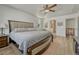 Bright main bedroom showcasing a ceiling fan, tray ceilings, and an ensuite bathroom entrance at 5238 Clearbrooke Ct, Castle Rock, CO 80104