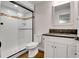 Bathroom featuring a shower, vanity, and white tiled walls at 10115 Foxridge Ct, Highlands Ranch, CO 80126