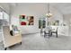 Bright dining area features high ceilings, a modern chandelier, and ample natural light from the window at 10115 Foxridge Ct, Highlands Ranch, CO 80126