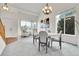 Elegant dining area with high ceilings, natural light, a chandelier, and comfortable seating for four at 10115 Foxridge Ct, Highlands Ranch, CO 80126