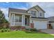Charming two-story home with well-manicured lawn, covered porch, and attached two-car garage at 10115 Foxridge Ct, Highlands Ranch, CO 80126