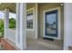 Covered front porch with white columns and railings, leading to a blue front door with glass panels at 10115 Foxridge Ct, Highlands Ranch, CO 80126