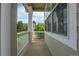 Inviting front porch with white railings, offering a view of the front yard and neighborhood street at 10115 Foxridge Ct, Highlands Ranch, CO 80126