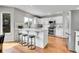 Modern kitchen with white cabinets, stainless steel appliances and hardwood floors at 10115 Foxridge Ct, Highlands Ranch, CO 80126