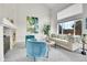 Bright living room featuring large windows, plush seating, fireplace and modern decor at 10115 Foxridge Ct, Highlands Ranch, CO 80126