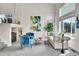 Bright living room featuring large windows, plush seating, fireplace and modern decor at 10115 Foxridge Ct, Highlands Ranch, CO 80126