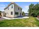 Exterior view of the home's backyard featuring a lush lawn and patio at 20455 E Grand Ln, Aurora, CO 80015