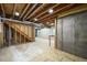 Unfinished basement ready for customization, featuring exposed beams and natural light at 20455 E Grand Ln, Aurora, CO 80015