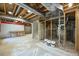 Open basement area with exposed ductwork and lighting fixtures, primed for finishing at 20455 E Grand Ln, Aurora, CO 80015