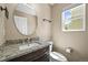 Compact bathroom with granite countertop, brown cabinets, and white toilet at 20455 E Grand Ln, Aurora, CO 80015