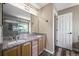 Double vanity bathroom with granite countertop, wood cabinets, and a walk-in shower at 20455 E Grand Ln, Aurora, CO 80015