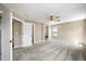 Spacious bedroom showcasing plush carpets, a ceiling fan, and access to the ensuite bath and closet at 20455 E Grand Ln, Aurora, CO 80015