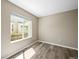 A simple bedroom with neutral walls, floors, and a window providing ample light at 20455 E Grand Ln, Aurora, CO 80015