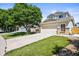 A beautifully landscaped home featuring a spacious driveway and a well-maintained lawn at 20455 E Grand Ln, Aurora, CO 80015