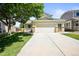 Well-maintained home with an attached garage, a front porch, and manicured landscaping at 20455 E Grand Ln, Aurora, CO 80015