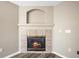 Close-up of a cozy fireplace with a classic tile surround and a decorative mantel at 20455 E Grand Ln, Aurora, CO 80015