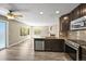 Kitchen island with stainless steel dishwasher, sink, and granite countertops under recessed lighting at 20455 E Grand Ln, Aurora, CO 80015
