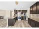 Well-lit kitchen with stainless steel appliances, granite countertops, and gray wood floors at 20455 E Grand Ln, Aurora, CO 80015