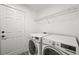 Efficient laundry area with modern, front-load washer and dryer and wire shelving at 20455 E Grand Ln, Aurora, CO 80015