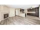 Spacious living room with a fireplace and wood floors that leads into a gourmet kitchen at 20455 E Grand Ln, Aurora, CO 80015