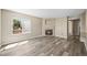 Comfortable living room with a cozy fireplace, natural light, and hardwood floors at 20455 E Grand Ln, Aurora, CO 80015