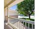 View from the covered porch of a home, with a cozy railing and well-kept landscaping at 20455 E Grand Ln, Aurora, CO 80015