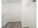 Bright walk-in closet features wall to wall shelving and carpeting at 20455 E Grand Ln, Aurora, CO 80015