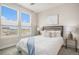 Inviting bedroom featuring a comfortable queen-size bed, contemporary decor, and bright windows at 9072 E 47Th Ave, Denver, CO 80238