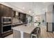 Open kitchen with stainless steel appliances, center island with seating, and stylish pendant lighting at 9072 E 47Th Ave, Denver, CO 80238