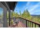 Private balcony offers serene treetop views and a cozy sitting area, ideal for relaxation at 10756 Timothys Dr, Conifer, CO 80433