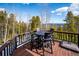 Relaxing deck view showcasing outdoor dining and beautiful mountain scenery for enjoying meals at 10756 Timothys Dr, Conifer, CO 80433