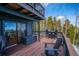 Outdoor deck area with ample seating, perfect for enjoying the surrounding nature and fresh mountain air at 10756 Timothys Dr, Conifer, CO 80433