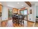 Charming dining area with mountain views, custom wood cabinets, and hardwood floors at 10756 Timothys Dr, Conifer, CO 80433