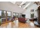 Bright living room with vaulted ceilings and skylights, hardwood floors, fireplace, and large windows at 10756 Timothys Dr, Conifer, CO 80433