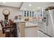 Modern bar area with a long counter, comfortable stools, a microwave and stainless steel appliances and cabinets at 8651 S De Gaulle Ct, Aurora, CO 80016